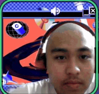 a bald man wearing headphones is looking at the camera in a video call .