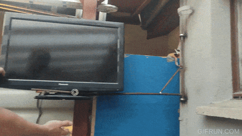 a person is holding a panasonic tv in their hand