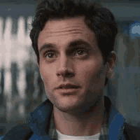 a close up of a man wearing a blue jacket