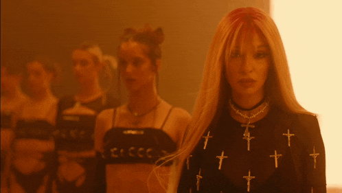 a woman wearing a shirt with crosses on it
