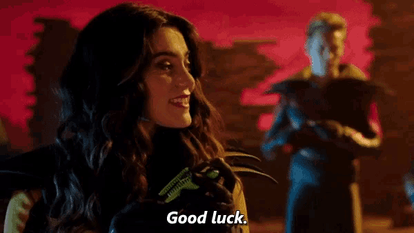 a woman is holding a grasshopper in her hand and says good luck