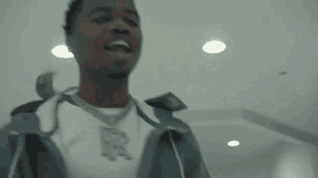 a man is throwing money in the air while standing in a room .