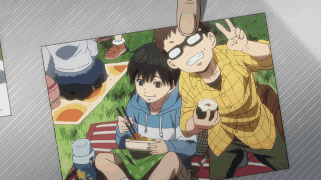 a picture of a man and a boy sitting on a blanket eating food