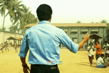 a man in a blue shirt is standing in front of a group of people with a youtube logo on his back