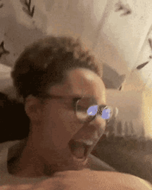 a woman wearing glasses is screaming with her mouth open