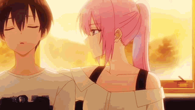 a boy and a girl are standing next to each other in a room .