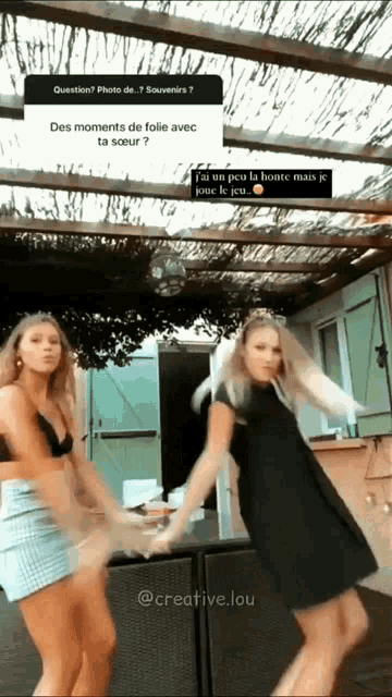 two women are dancing in front of a sign that says question photo de