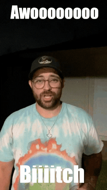 a man wearing glasses and a tie dye shirt says aw000000 biiitch