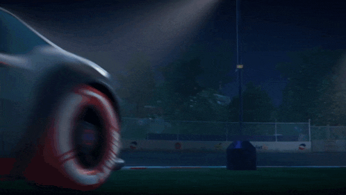 a car is driving on a track at night with a sign that says no parking