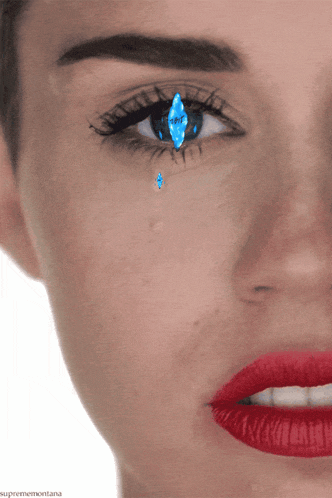 a close up of a woman 's eye with a tear coming out of it