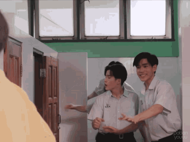 a couple of boys are standing in a room with the words spoken you on the bottom