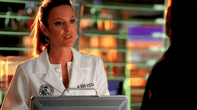 a woman in a white lab coat has the name boa vista on her shirt