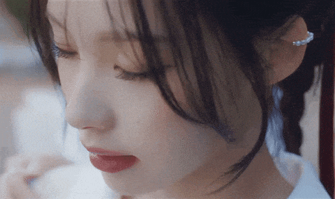 a close up of a woman 's face with her eyes closed and red lips