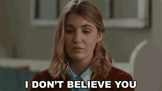 a woman says " i don 't believe you " while wearing a red jacket