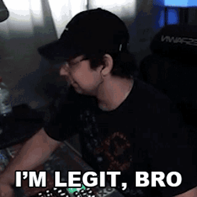 a man wearing a hat and glasses says " i 'm legit bro " while playing a video game