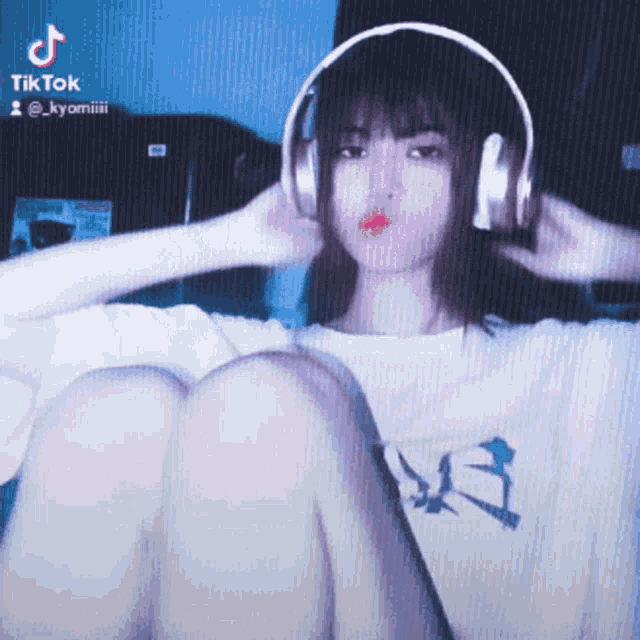 a girl wearing headphones and a tiktok logo