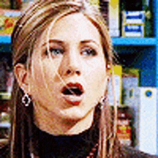 a close up of a woman 's face with her mouth open in front of a store shelf .