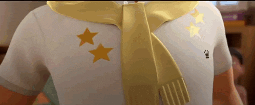 a close up of a person wearing a yellow scarf and a white shirt with two yellow stars on it .