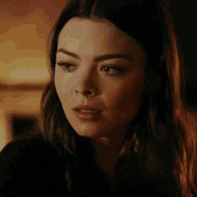 a close up of a woman with a tear running down her cheek