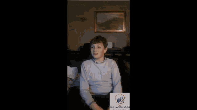 a boy in a living room with a chris weatherburn logo
