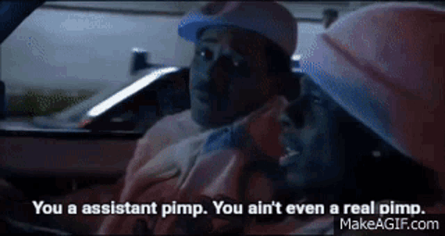 two men in a car with one saying " you a assistant pimp you ain t even a real pimp "
