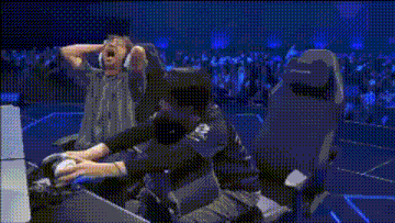 a person wearing headphones is making a funny face while sitting in a chair .