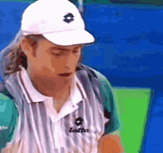 a man wearing a white hat and a shirt that says lotto on it