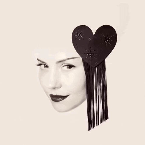 a black and white photo of a woman 's face with a black heart on her head