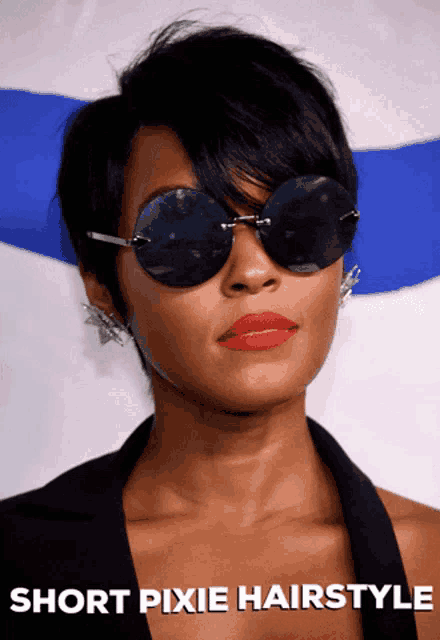 a woman with short pixie hairstyle wearing sunglasses and red lipstick