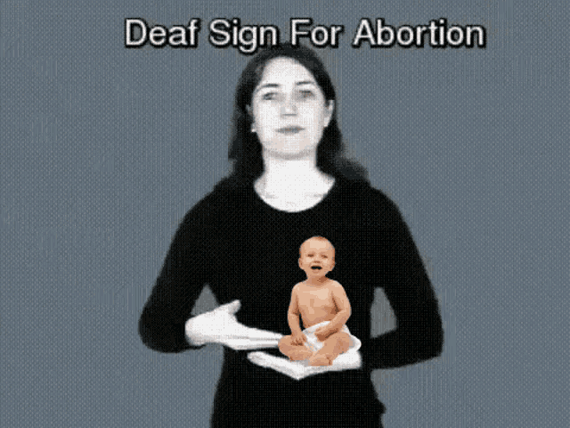 a woman is giving a deaf sign for abortion while holding a baby .