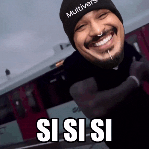 a man wearing a beanie that says multiverse is smiling