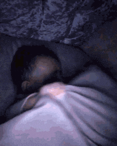 a person is sleeping in a dark room