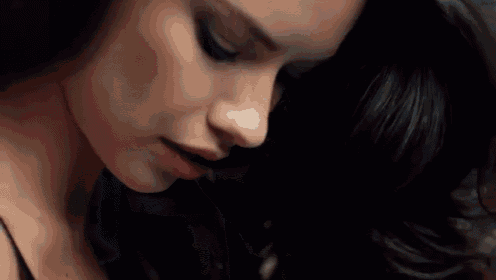 a close up of a woman 's face in a dark room .