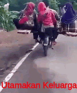 a group of people are riding a motorcycle down a road with the words " utamakan keluarga " in red