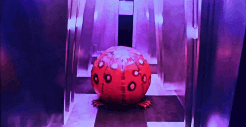 a red ball with circles on it is in a room