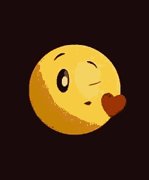 a yellow smiley face is blowing a kiss with a red heart coming out of its mouth .