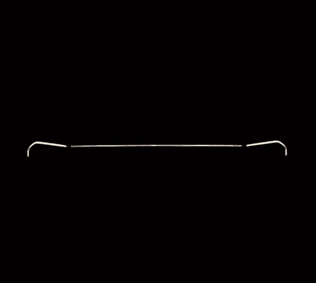 a white line on a black background is a silhouette of a car 's headlight .