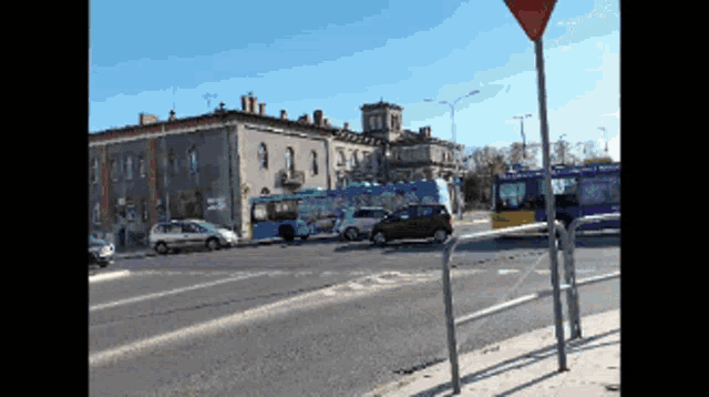 a pixelated image of a street scene with a red sign in the foreground