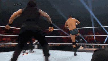 two men are wrestling in a ring with the words raw on the bottom right