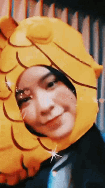 a woman wearing a yellow hat with hearts on her cheeks