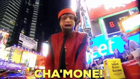 a man in a red jacket is standing in front of a sign that says cha mone
