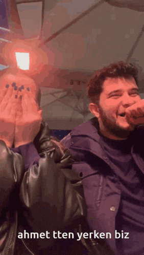 a man and a woman covering their faces with their hands with the words ahmet ttten yerken biz written below them