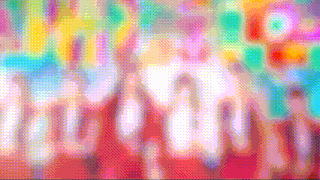 a blurry picture of a group of people standing in front of balloons .