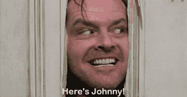 a man is looking through a door with his mouth open and the words `` here 's johnny '' written below him .