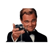 a man in a suit and bow tie is holding a glass of wine .