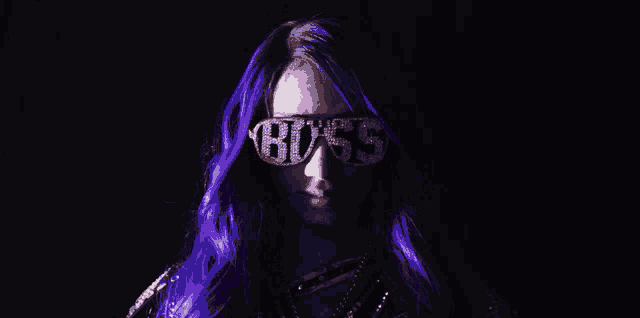 a woman with purple hair is wearing a pair of sunglasses that say boss