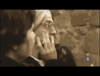 a woman is touching another woman 's face and the number 1 is on the bottom right