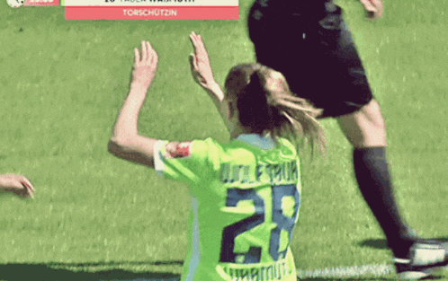 a female soccer player with the number 28 on her shirt