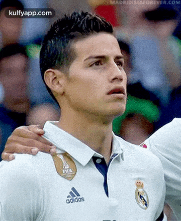 a close up of a soccer player wearing a white adidas shirt