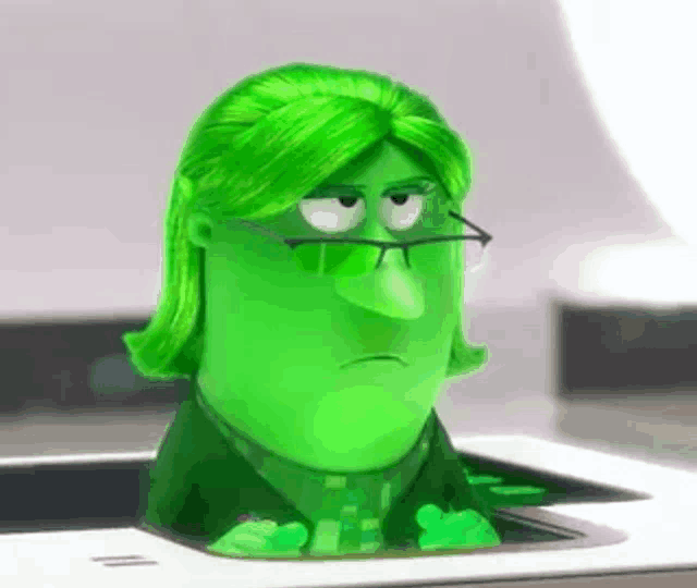 a green cartoon character with glasses and green hair is sitting in a printer .